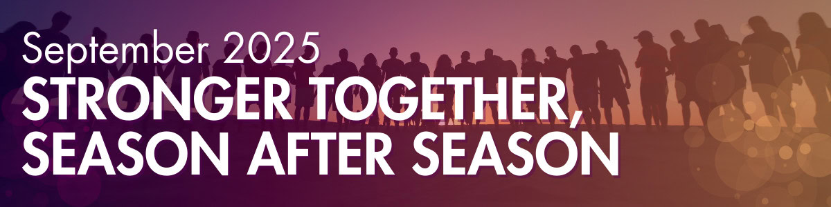 A group of people standing in front of a sunset.