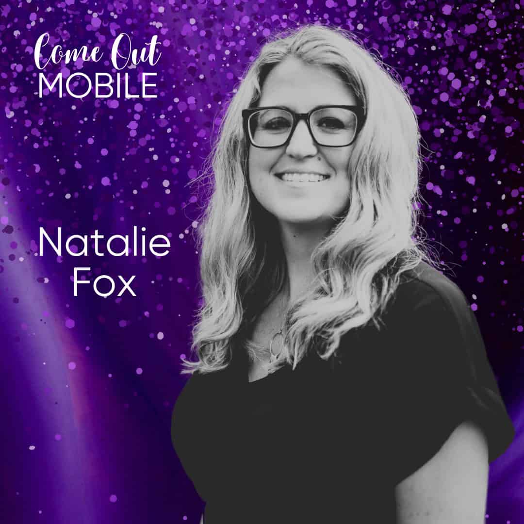 A person with long hair and glasses stands smiling against a vibrant purple background with the text "Come Out Mobile" and "Natalie Fox.