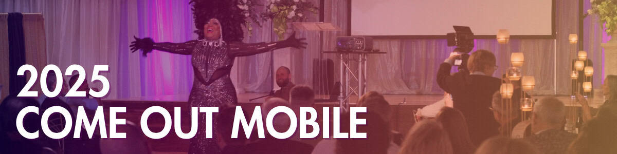 Performer on stage in front of an audience with "2025 Come Out Mobile" text overlay; event setup includes candles, projector screen, and a person filming.