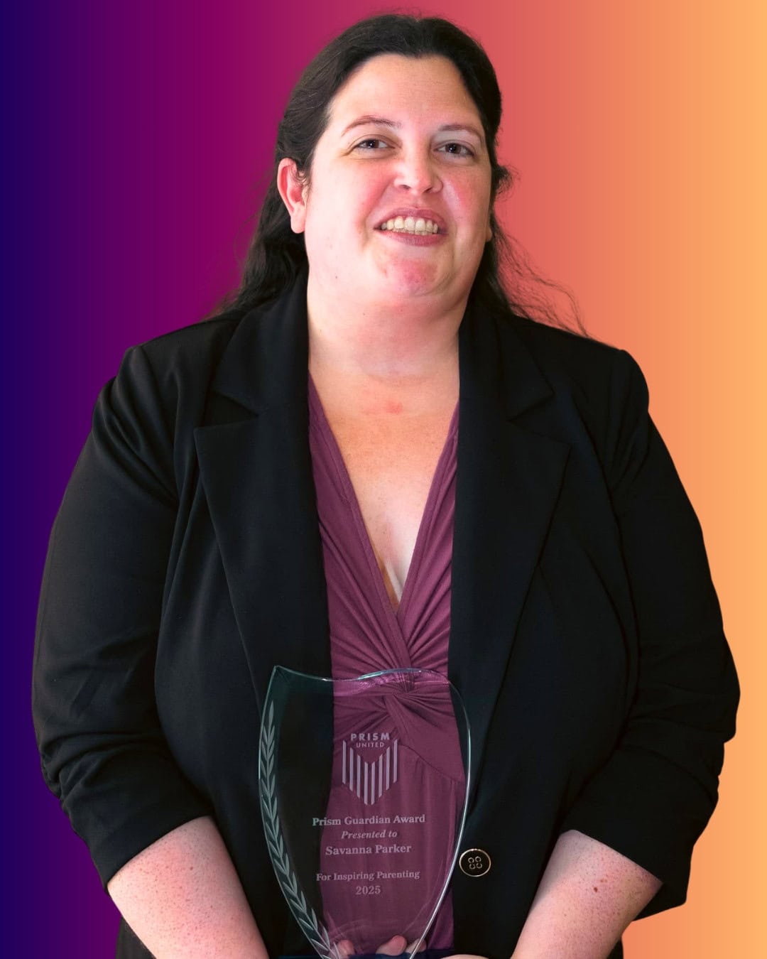 SavannaParker A woman in a black blazer holds a glass award and smiles at the camera. The background features a gradient from purple to orange.