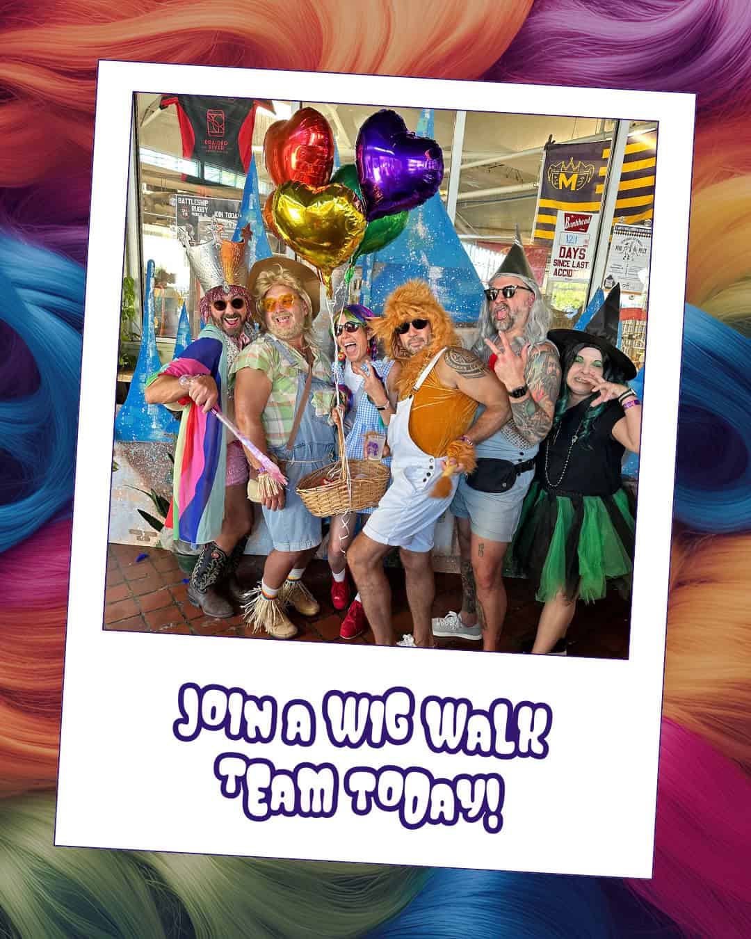 Six adults in colorful costumes pose together, holding balloons, with a sign below reading "Join a Wig Walk Team Today!" The background features a swirl of rainbow-colored hair.