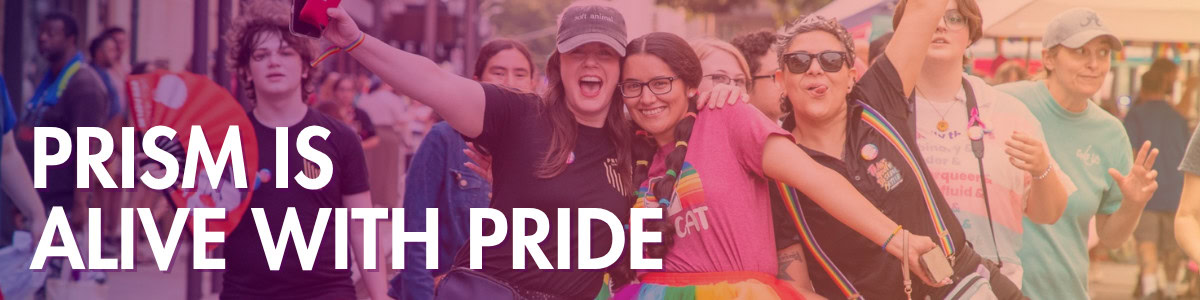A group of people in colorful clothing smile and pose together at a pride parade; text reads "PRISM IS ALIVE WITH PRIDE.