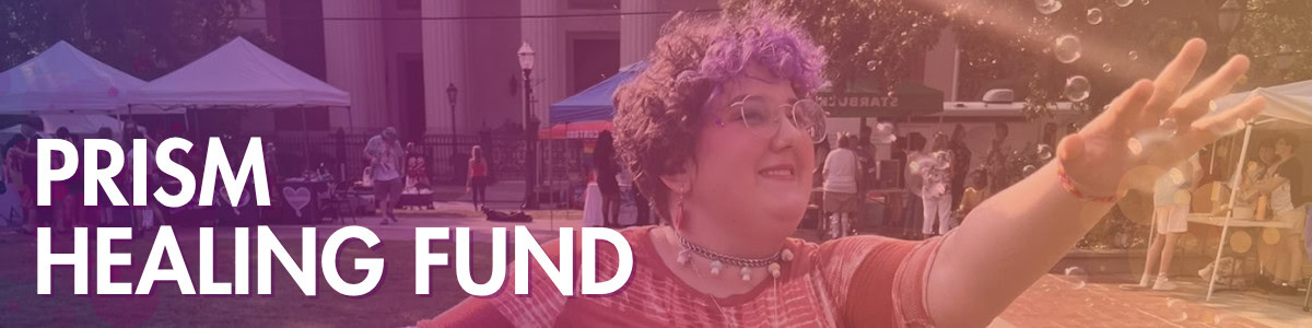 A person with short purple hair and glasses reaches out among bubbles at an outdoor event, with “PRISM HEALING FUND” text overlayed.
